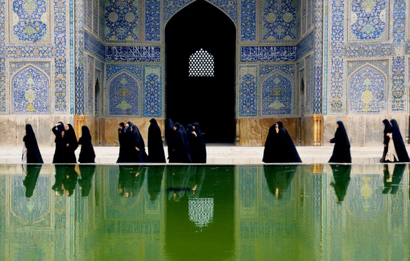 Muslim women wearing burqas in the courtyard of the Shah Mosque, Isfahan, Iran. Photo by LBM1948 on Wikimedia Commons.  (CC BY-SA 4.0).