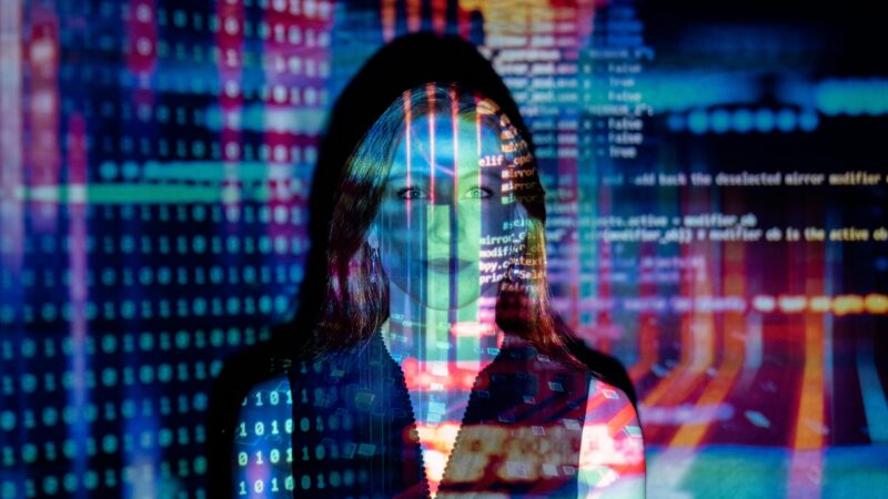 Code projected over woman. Photo by ThisIsEngineering. Free to use via Pexels.